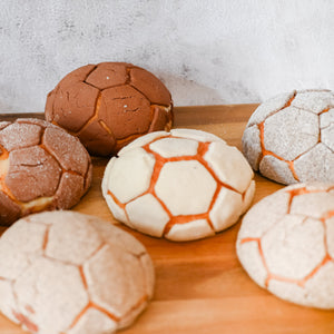 Decorative bread rolls with football  pattern on a wooden board